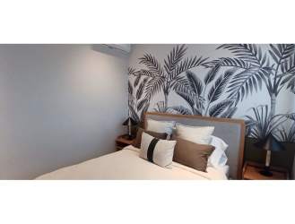 Bright bedroom with en suite bath, AC, built-in closet, and balcony at Playa del Sol Panama