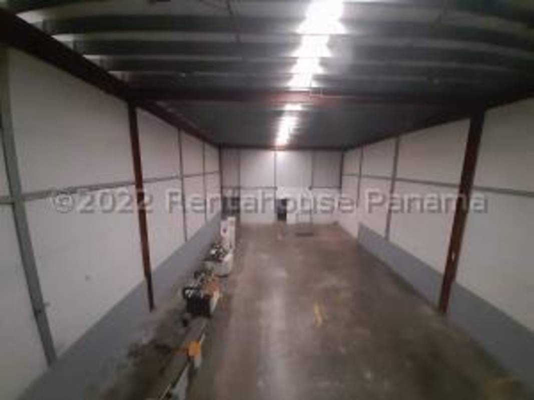 Glass door entry and adjacent roller shutter on commercial building Tocumen Panama