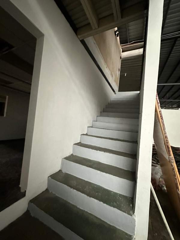 Warehouse interior featuring exposed steel beams and mezzanine office Don Bosco Panama