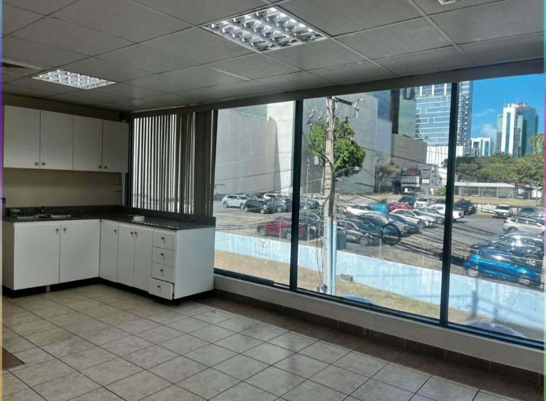 Modern office kitchenette with cabinets, granite countertop and city views PH Obarrio Business Center