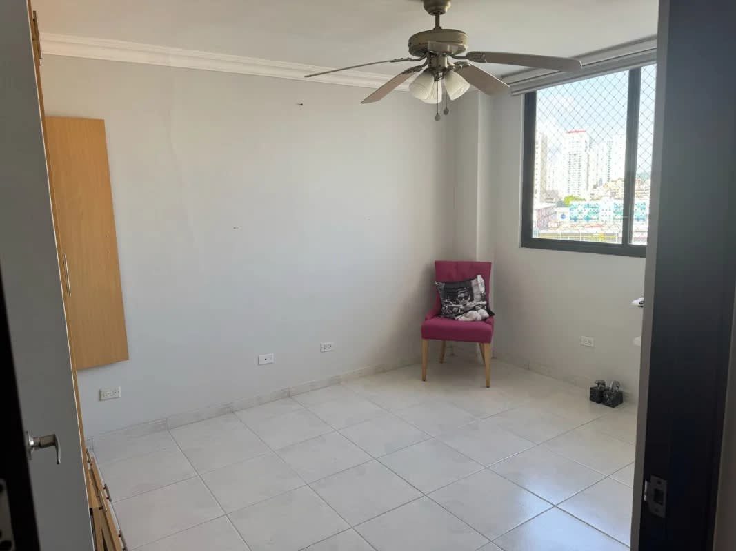 Master bedroom with large window and four-poster bed frame, tile floor PH La Fontana Panama City