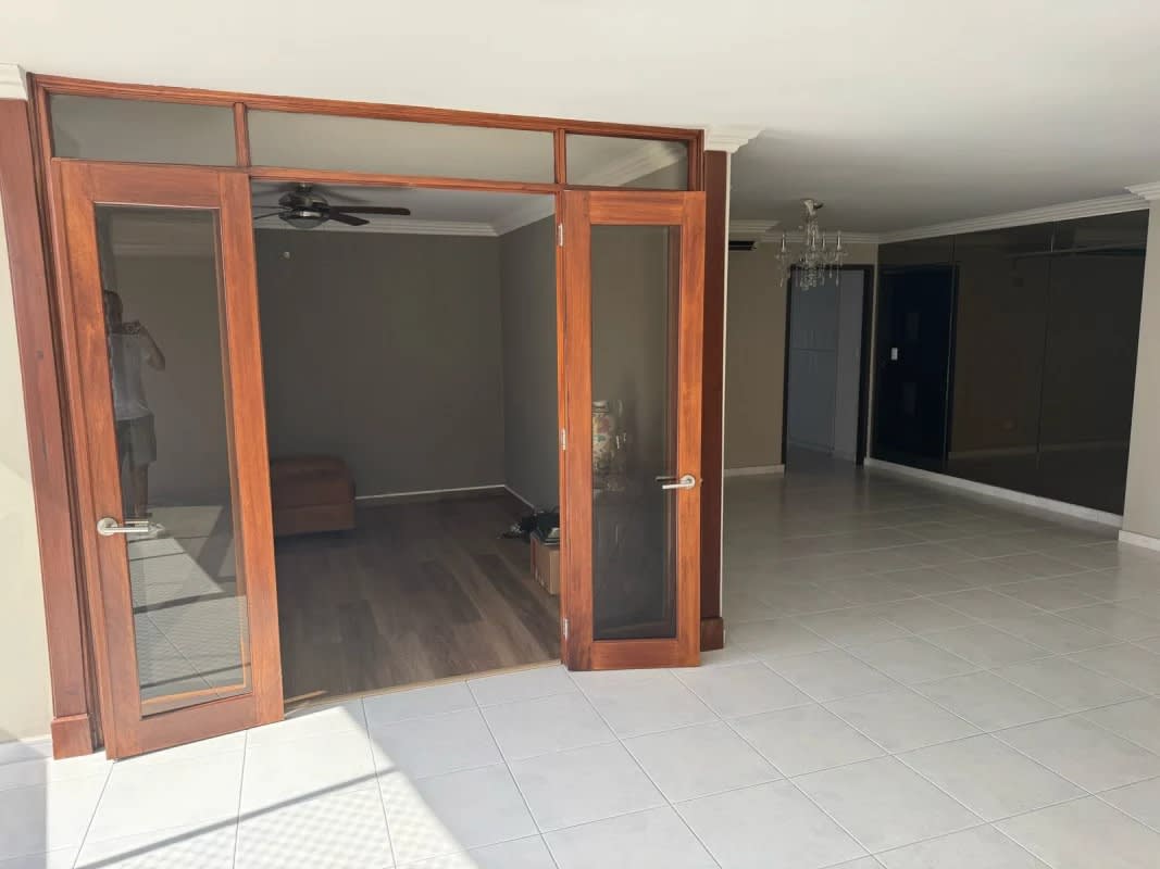 Living space with French doors leading to enclosed study at PH La Fontana Obarrio Panama City