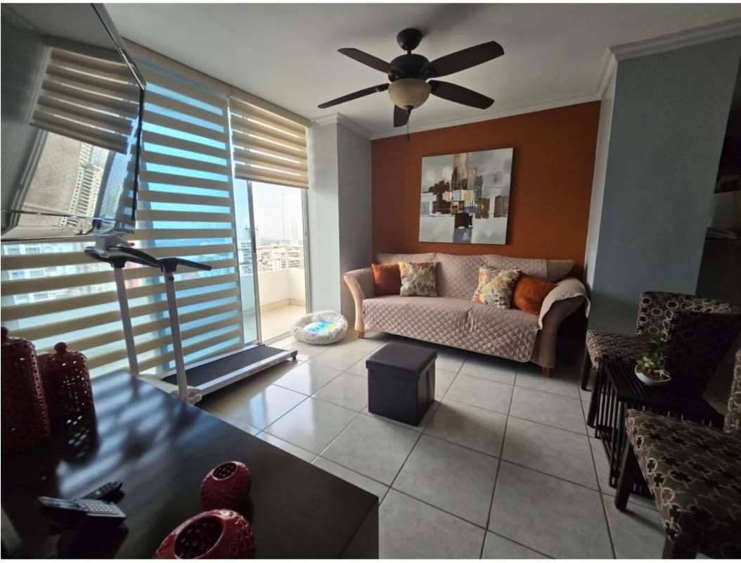 Living room with panoramic windows and ceiling fan in high-rise PH Sunshine Carrasquilla Panama City