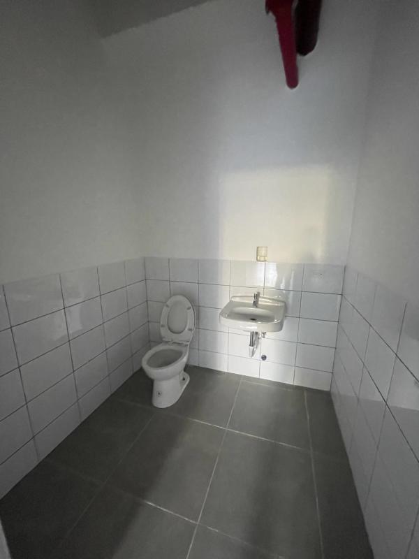 Empty open plan commercial interior with high ceiling and tile floors PH Casa Korsi Casco Viejo