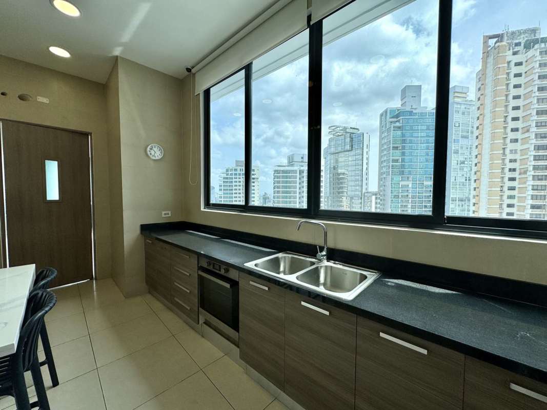 Open kitchen with granite countertops marble floors in luxury condo PH Deluxe Residences Punta Paitilla Panama