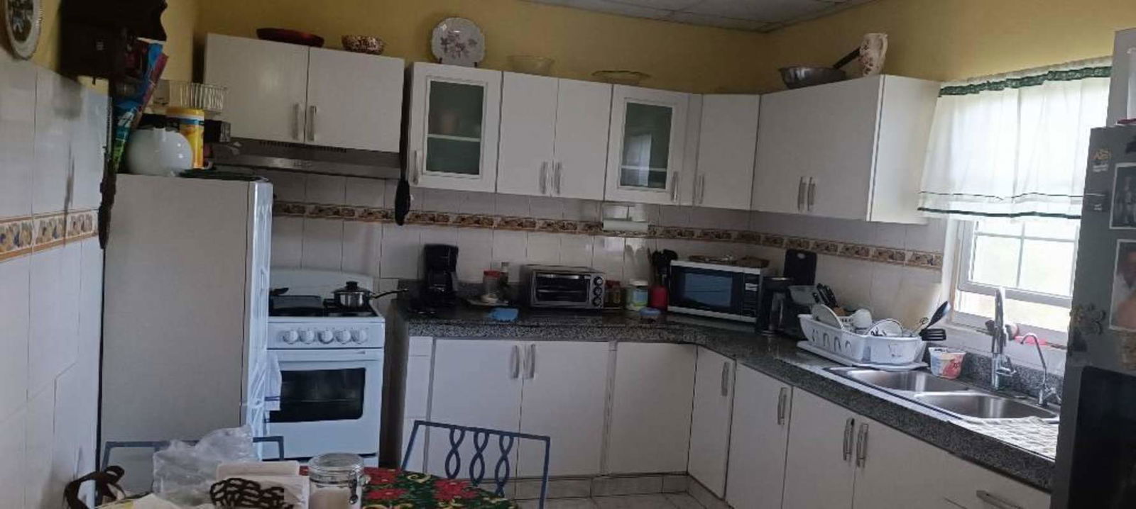 Traditional kitchen with granite countertops, appliances, ceramic backsplash Cerro Azul Panama