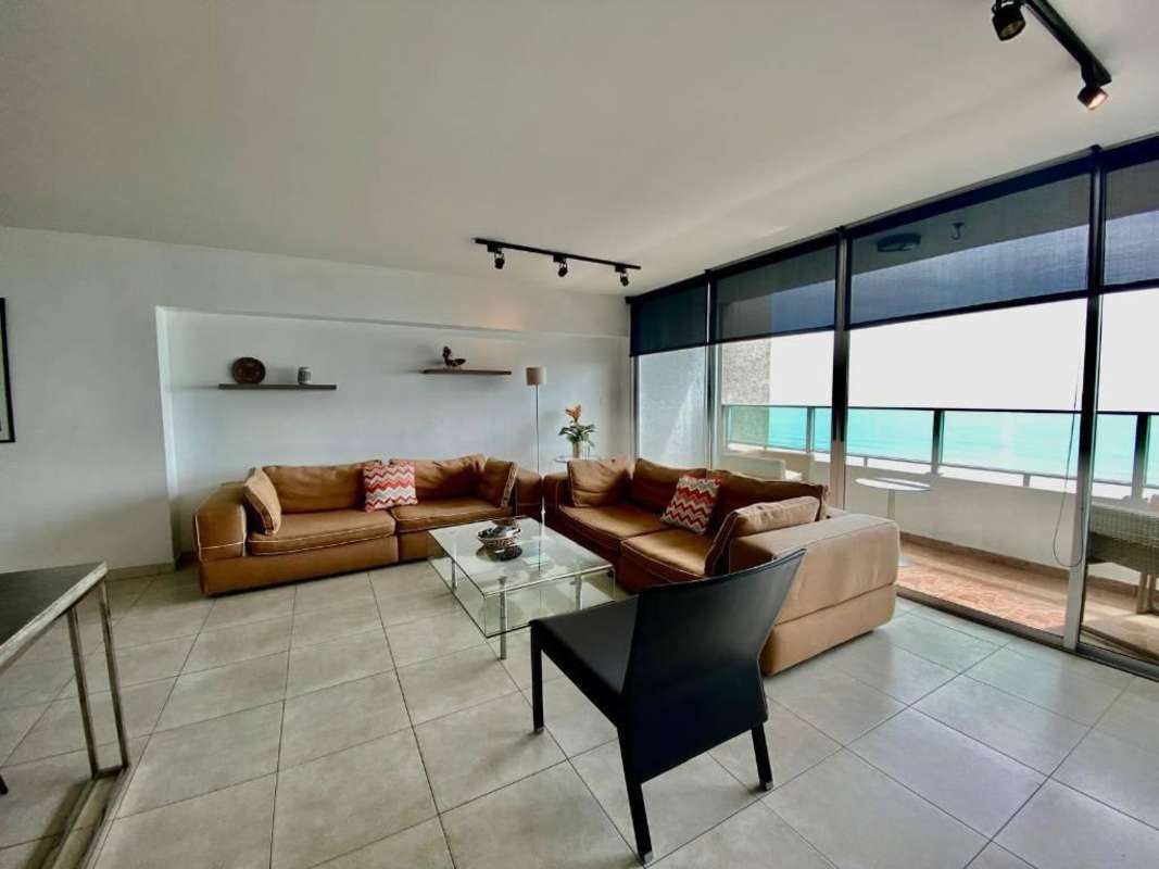 Spacious living and dining area with large ocean view windows Punta Pacifica apartment Panama