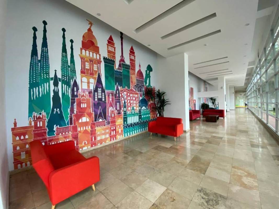 Modern lobby with artistic mural and concierge desk in PH Ocean Park Tower Punta Pacifica