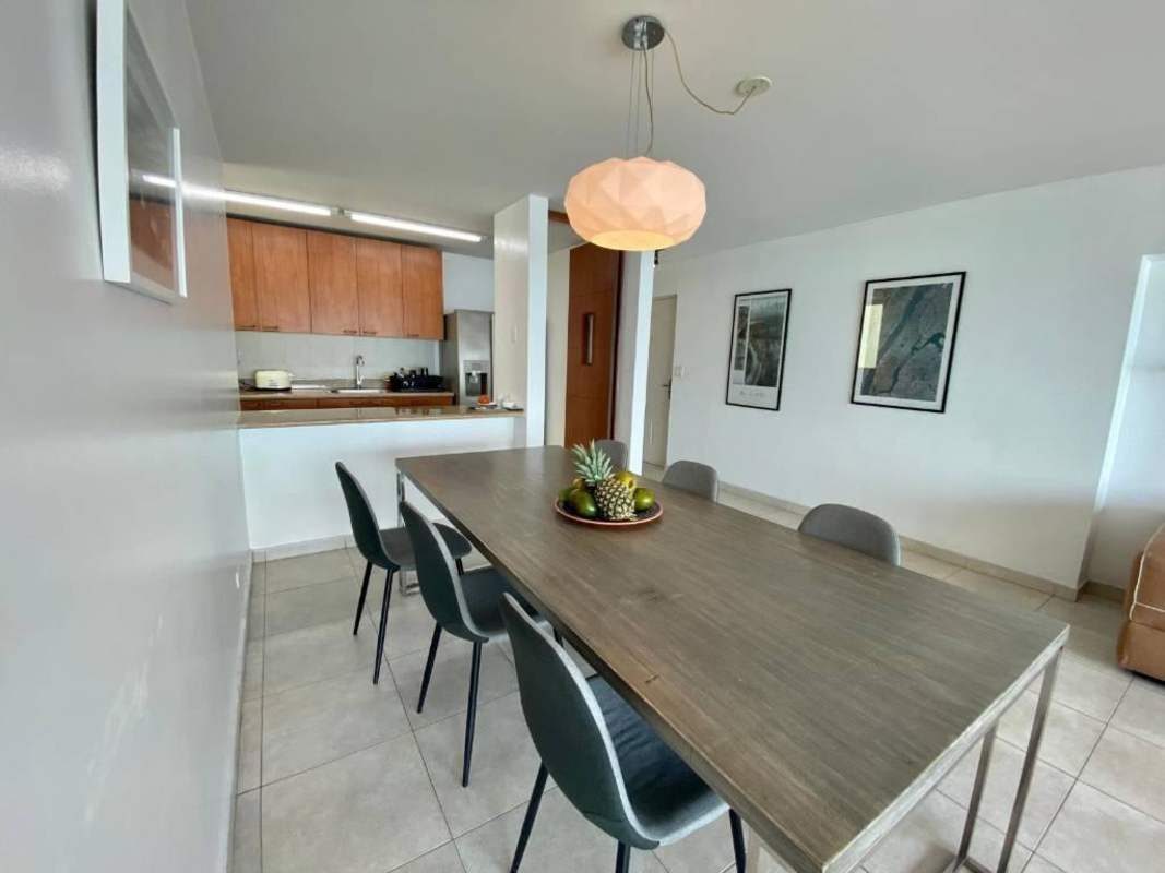 Dining space adjacent to modern kitchen in ocean view apartment Punta Pacifica Panama