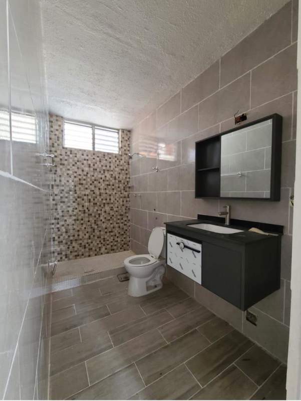 Bathroom with mosaic tiled walk-in shower, vanity and modern finishes in PH San Francisco Park Panama