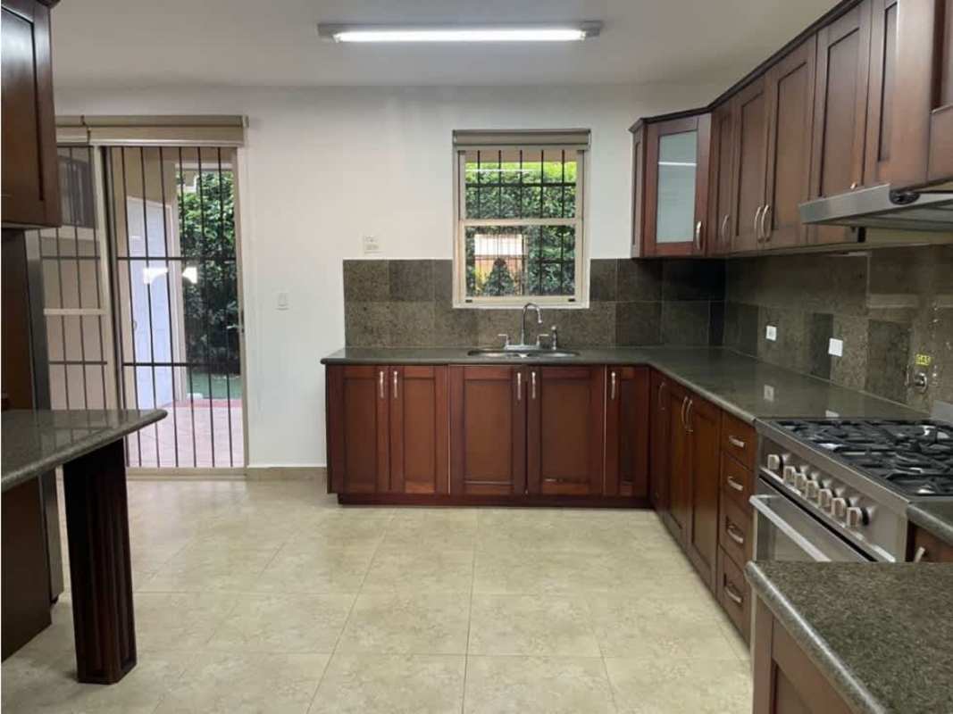 Spacious traditional kitchen with granite countertops, wood cabinets in PH Embassy Gardens Clayton Panama