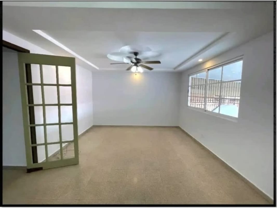 Living room with beige carpet, large window, ceiling fan, glass door Cerro Viento Panama