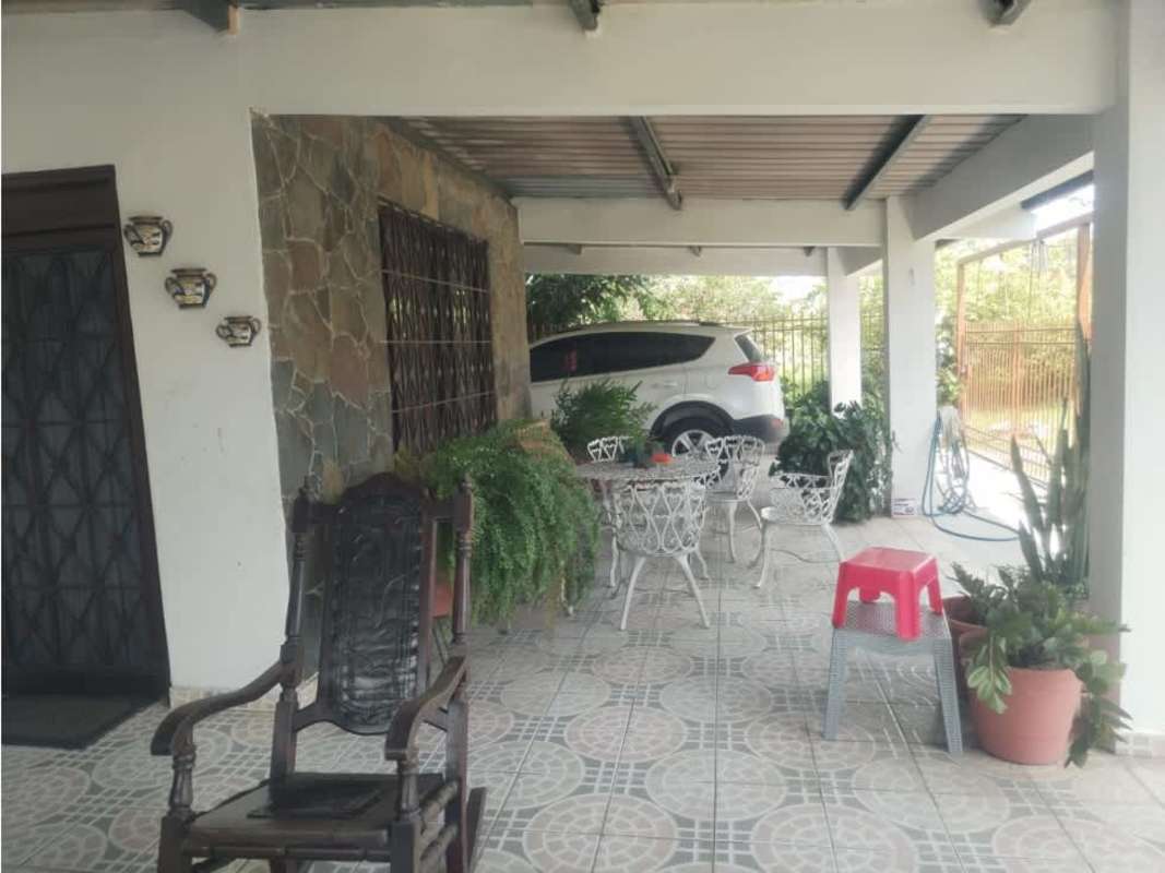 Rustic covered patio and carport with potted plants at house with workshop Pacora