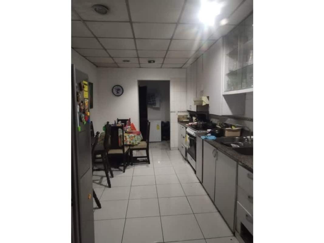 Traditional white kitchen with dining area in house at Pacora Altos de Tatare for sale