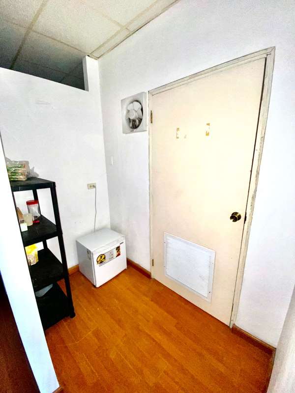 Small utility room wood floors white door and storage mini fridge Plaza Aventura El Dorado