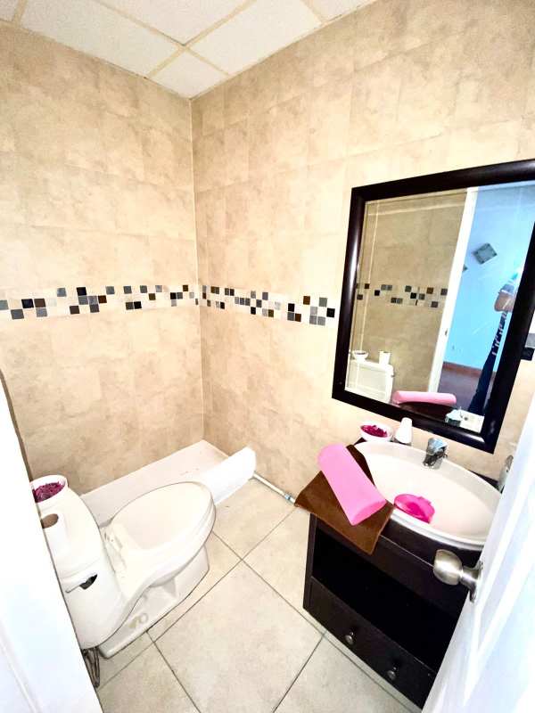 Commercial utility room with drop ceiling wood floors minimal furniture Plaza Aventura El Dorado Panama