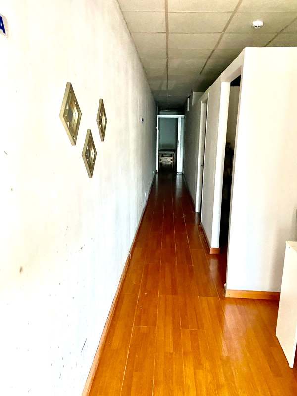 Long corridor interior with wood flooring drop ceiling Plaza Aventura El Dorado Panama City