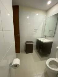 Living room with balcony access and natural light in PH Woodlands Panama Pacifico apartment