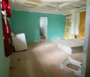 Room with turquoise walls exposed roof unfinished interior under renovation Burunga Arraiján Panama