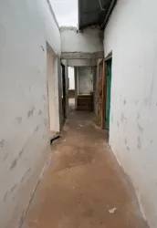 Unfinished hallway with concrete floor open doorways Burunga rental house Panama