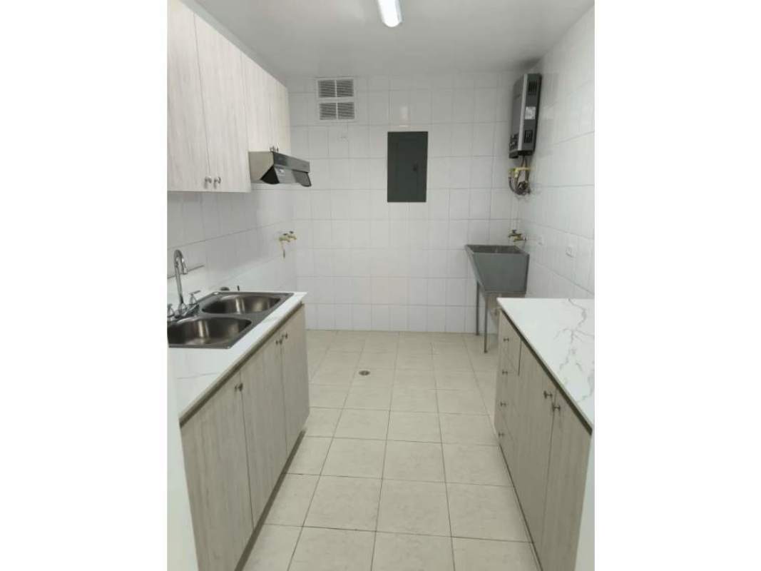 Kitchen with marble counters, cabinets, and utility sink at PH Majestic Gardens Panama City