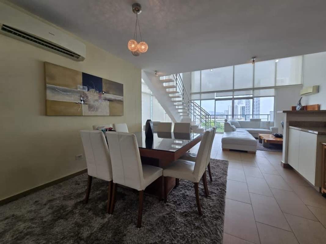 Furnished open kitchen with granite counters, breakfast bar, stainless appliances at PH El Cangrejo Loft Panama City