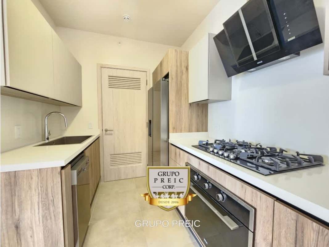 Modern living space with sliding glass doors to balcony, city skyline views, Santa Maria Panama