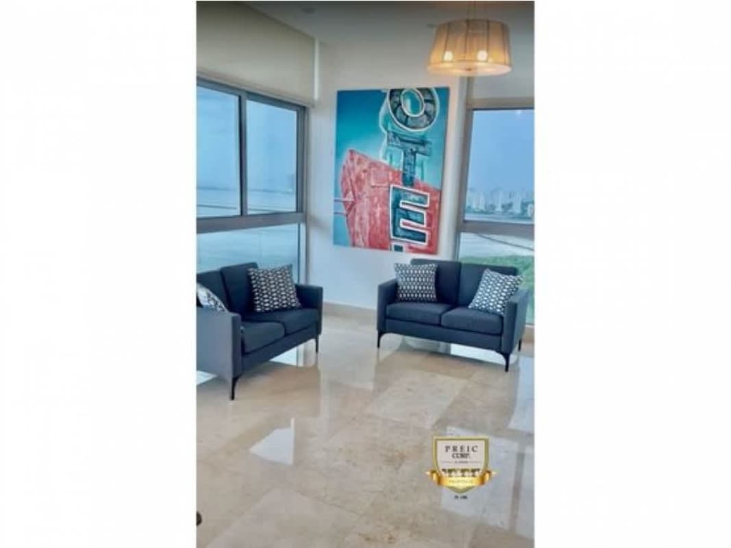 Stylish living room with panoramic windows showing ocean and skyline, PH Mirador Panama City