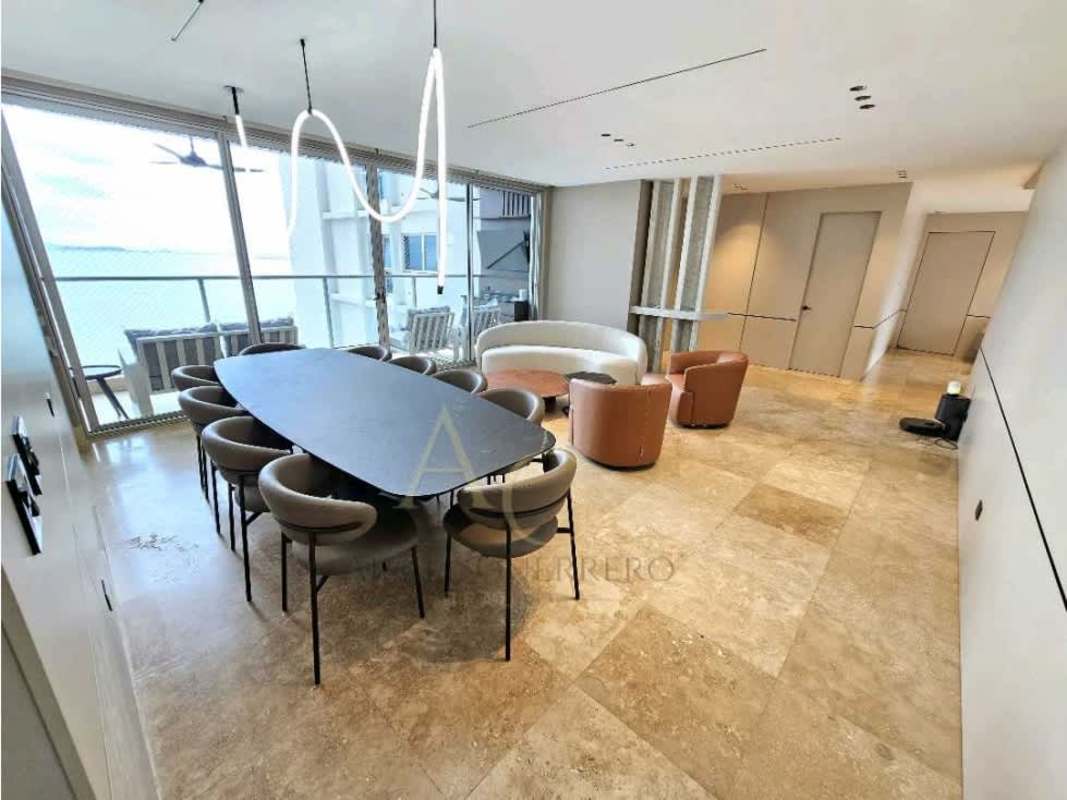 Dining and living room with ocean view balcony access in luxury apartment at PH Q Tower Punta Pacifica