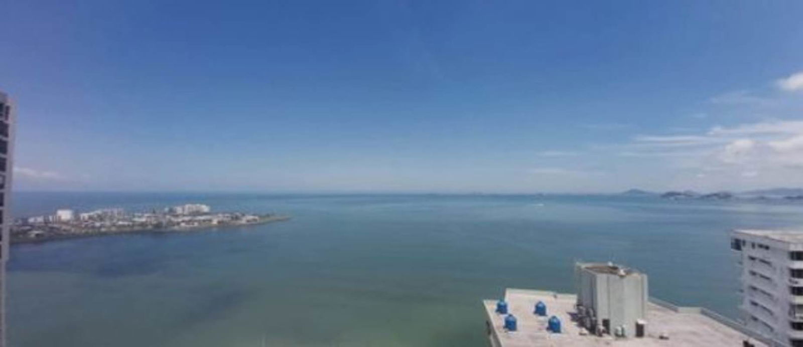 Spacious living room with floor-to-ceiling glass and ocean panorama PH The Towers Punta Paitilla