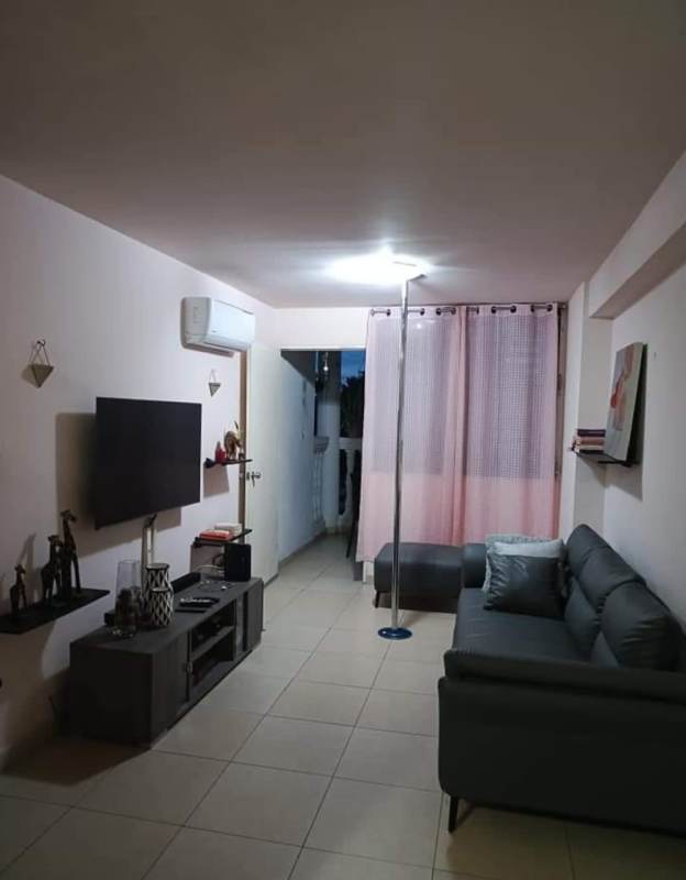 Living room with entertainment console, AC unit, gray sofa, TV in PH La Cresta Panama City