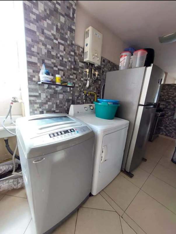 Laundry room with washing machine, dryer, refrigerator, shelves, in PH La Cresta Panama City