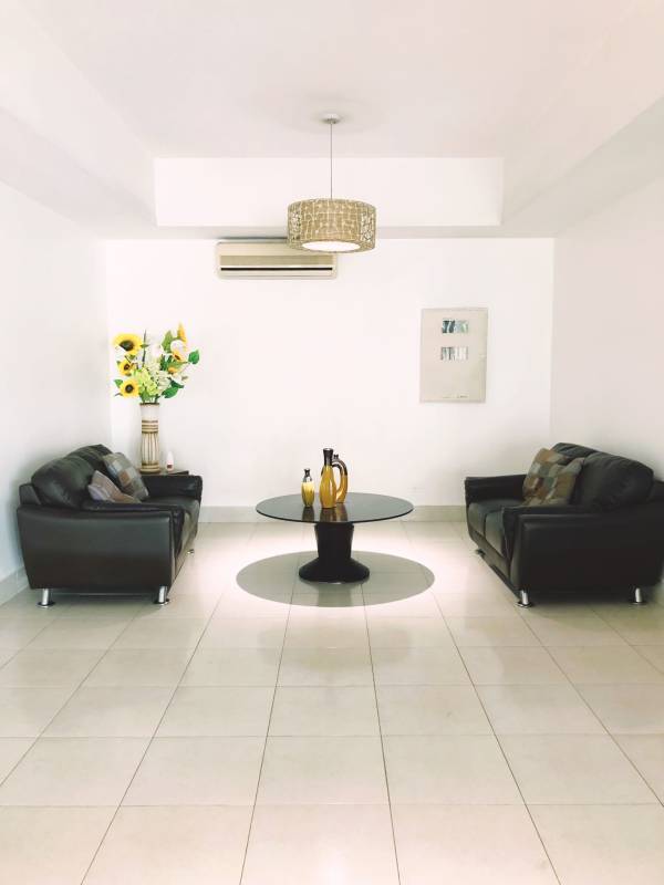 Living room with AC, black sofas, tile floors at PH Majestic Edison Park Panama