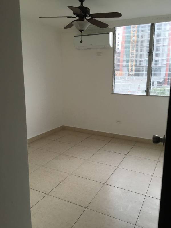 Enclosed balcony with safety netting, tile floor and city skyline views in PH HIP Tower