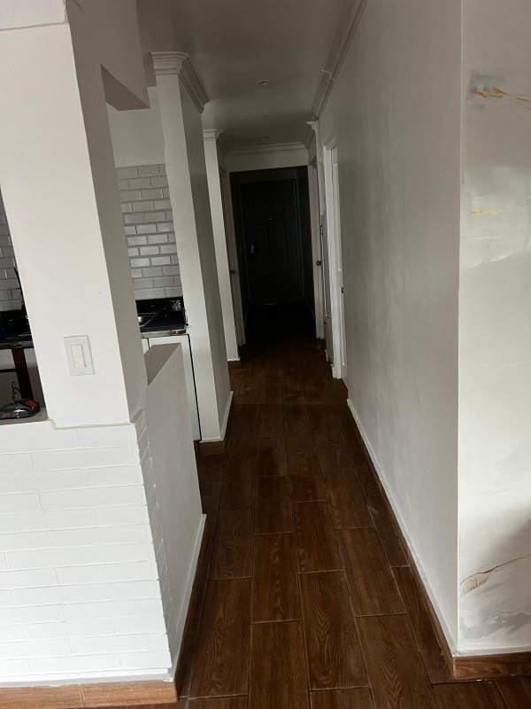 Interior hallway with modern subway tile backsplash and marble tile accent in Betania house Panama