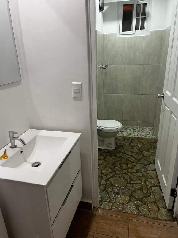 Minimalist bathroom with stone tile shower area in Betania house for rent Panama
