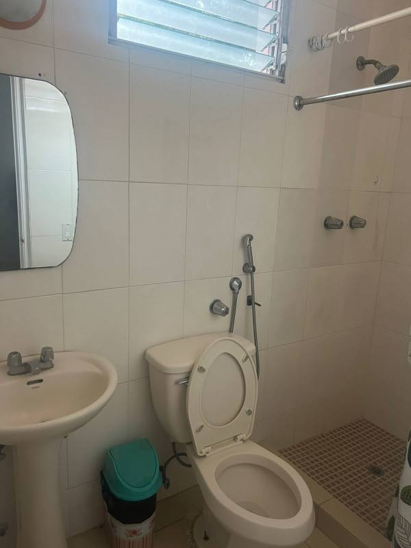 Simple bathroom with shower, pedestal sink, mirror and tiled walls PH Las Hortensias Panama City