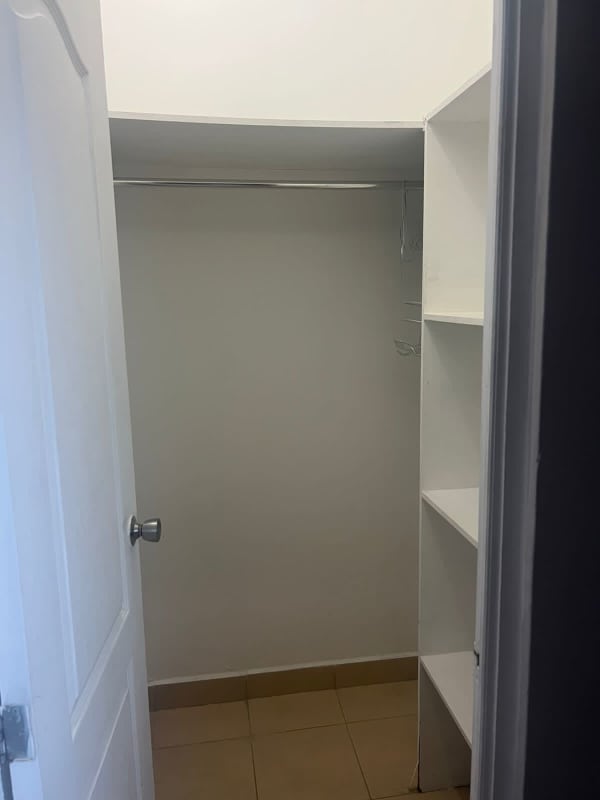 Open walk-in closet with hanging rod and shelving in PH Las Hortensias Panama City