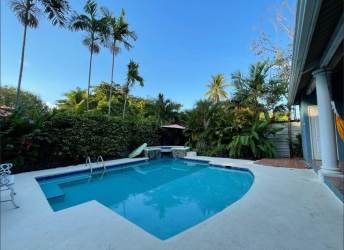 Private swimming pool with palm trees garden in luxury house Coronado Panama