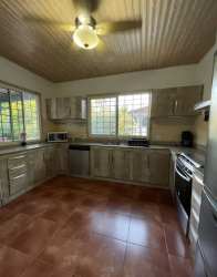 Large kitchen with wood cabinets and tiled countertops Coronado Panama