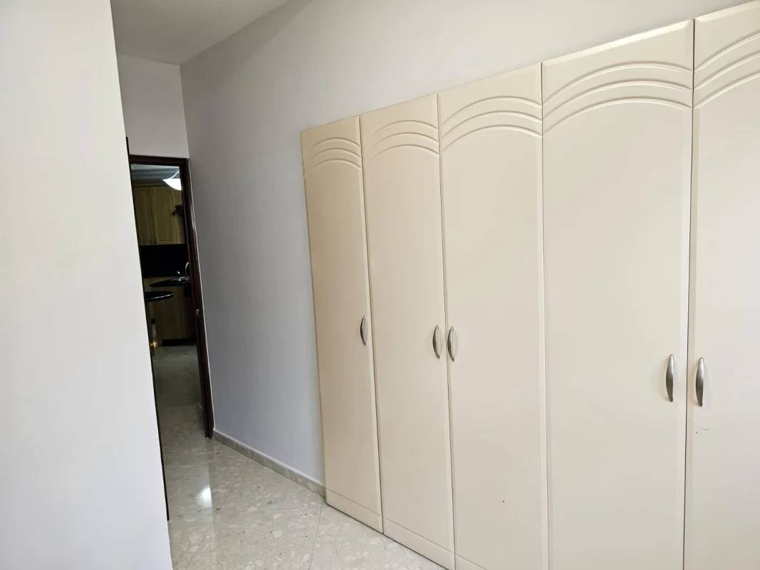 Bright minimalist bedroom with large wardrobe tiled floors luxury house Condado del Rey Panama