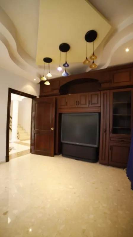 Spacious living room marble floors entertainment center Condado del Rey house for sale