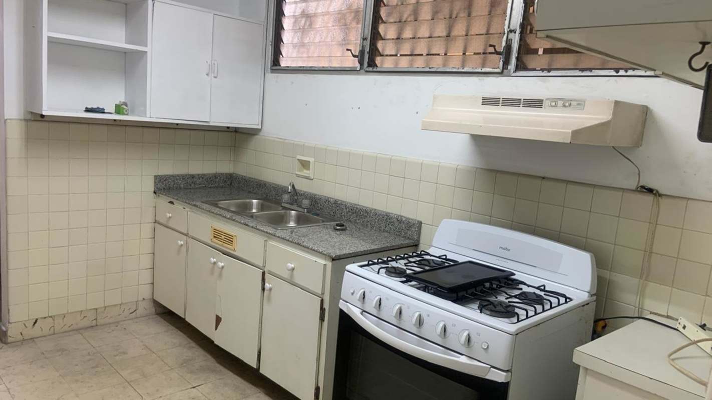 Kitchen with granite countertops, gas stove and cabinets in PH Obarrio Tower Panama