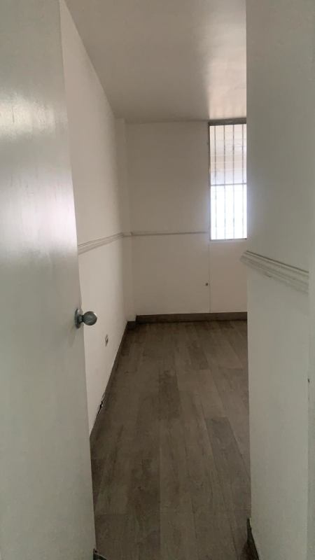 Small storage room with wood floor, window with bars inside PH Obarrio Tower Panama