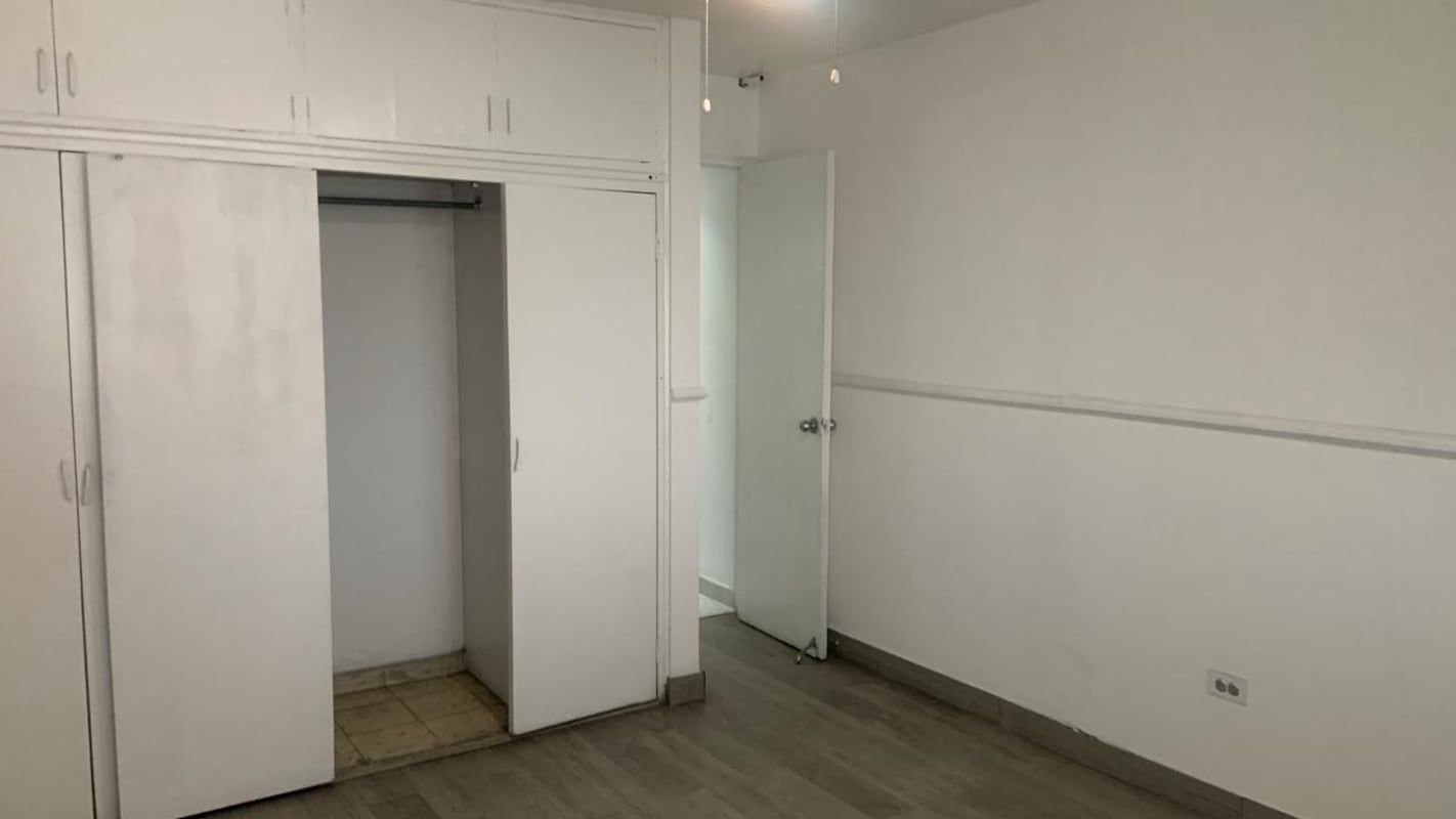 Bedroom with louvered closets, wood floors at PH Obarrio Tower Panama City