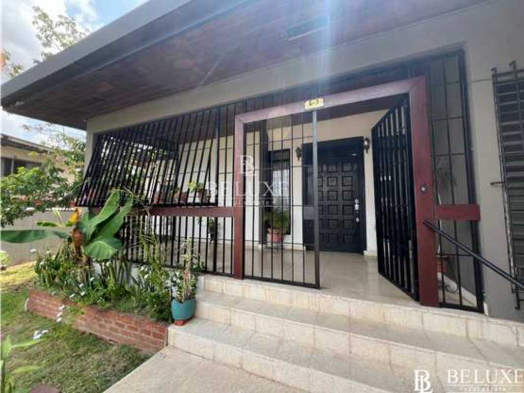 Traditional living room with wood ceilings and large windows in Los Angeles Betania home