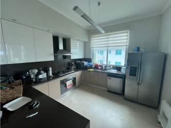 Fully equipped kitchen with modern appliances and large window at PH Balboa Bijao Panama