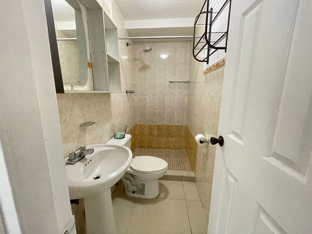 Modern kitchen with wood cabinets granite countertops tile flooring PH El Ingenio Betania Panama