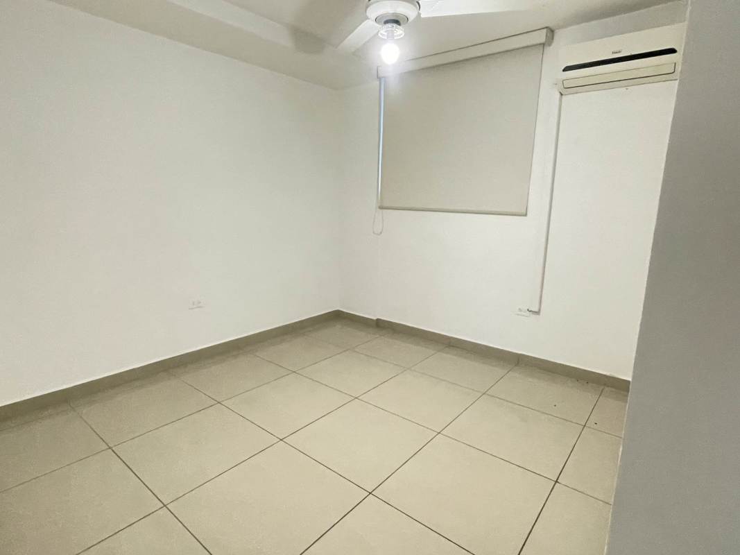 Minimalist bedroom with beige tiles ceiling fan AC closet Betania Panama