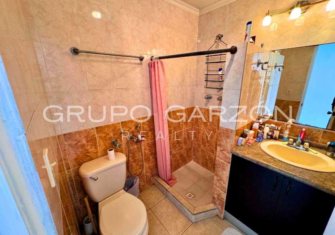 Bathroom with beige tiles, walk-in shower, modern fixtures at PH Sunset Place Panama City